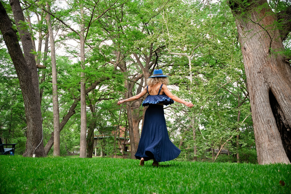 Stephenie Purnell in expressive movement, twirling outdoors